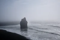 A photo of a rock in the ocean in Iceland